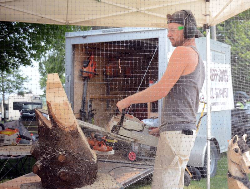 Jeff Coss of Bear Grove Chainsaw Carvings makes one of his creations at a past Adair County Fair.