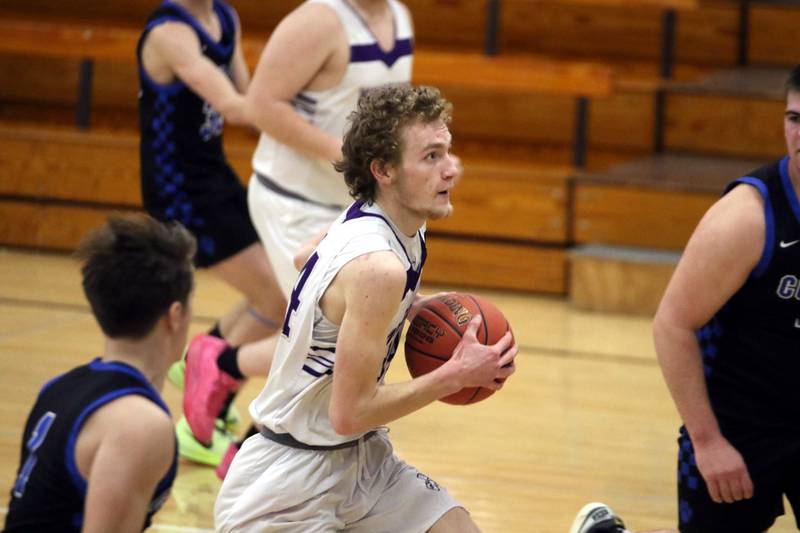 NV senior Paul Berg drives to the hoop in a late-season basketball game against CAM. Berg is a Pride of Iowa Conference honorable mention selection.
