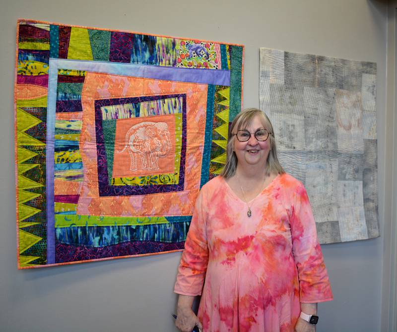 Joyce Franklin stands with her two quilts in the Quilt Rebels exhibit during an open reception on Friday.