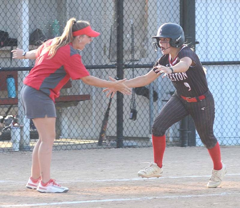 Evy Marlin looks toward teammates at home plate and greets assistant coach Gracie Hagle after rounding third base moments after Marlin's first home run as a Panther in Monday's 12-10 win over Atlantic.