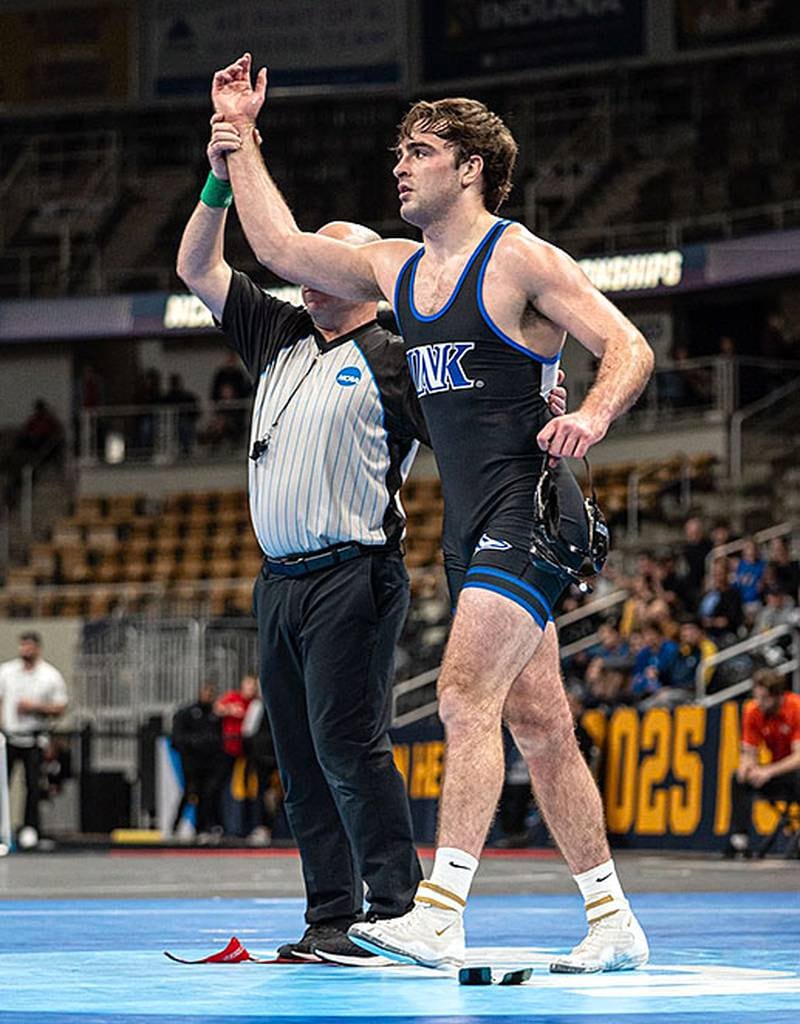 Nebraska-Kearney wrestler Jackson Kinsella of Creston raises his hand in victory after defeating Max Ramberg of Augustana, 7-2, for third place in the NCAA Division II tournament.