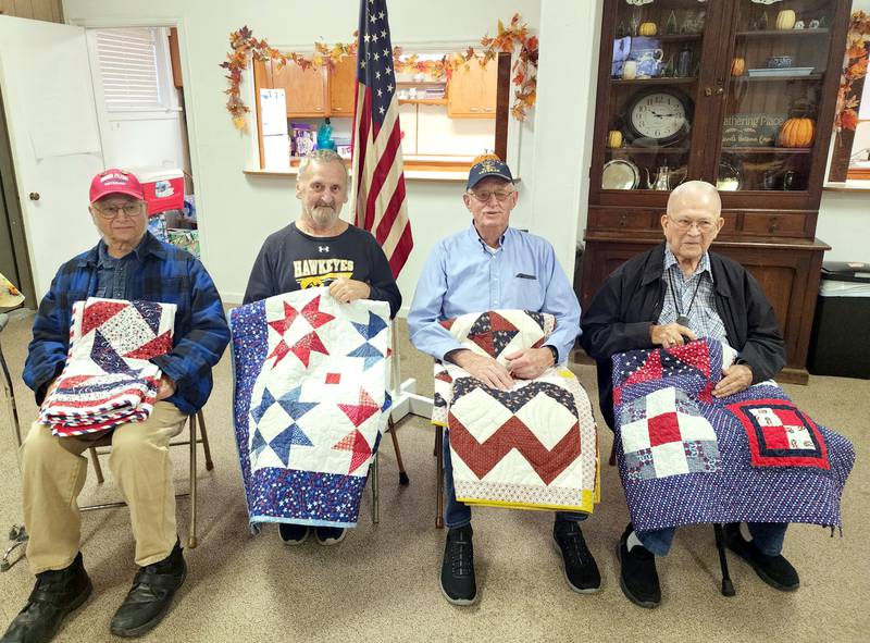 Receiving quilts from the Fabric and Friends Quilt Guild Saturday were Eugene Hardisty, Timmie Schultz, Dennis Johnson and Oliver Sorensen.