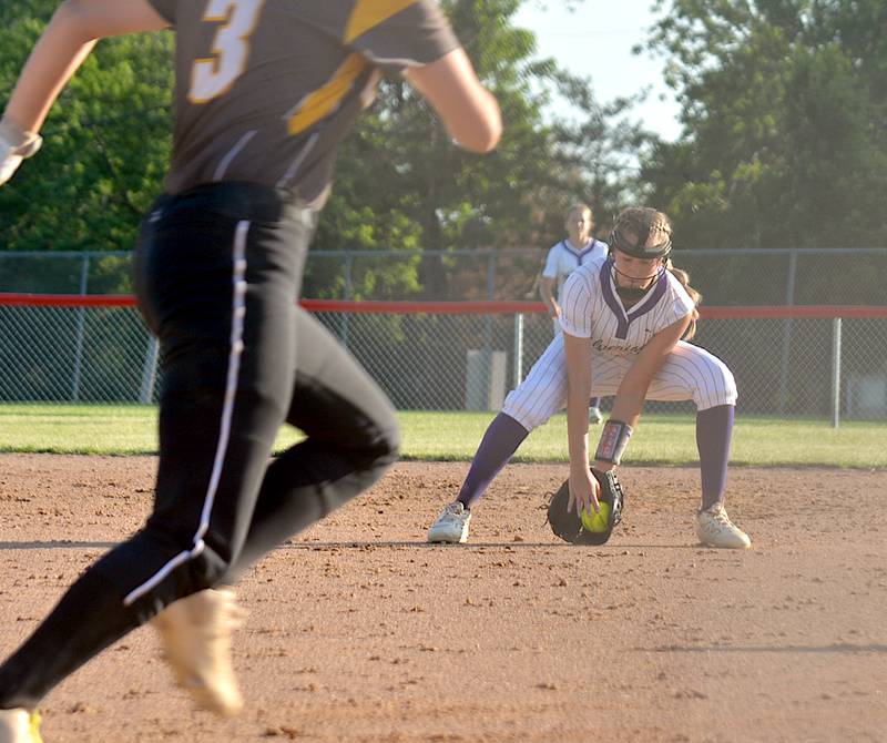 Wolverine freshman Taylor Laughery scoops up a grounder hit to second base during a softball game against Lenox in Orient Friday.
