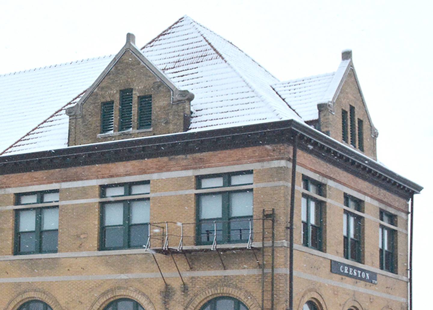 The upper window sections on the roof are what is represented in the new Creston logo.