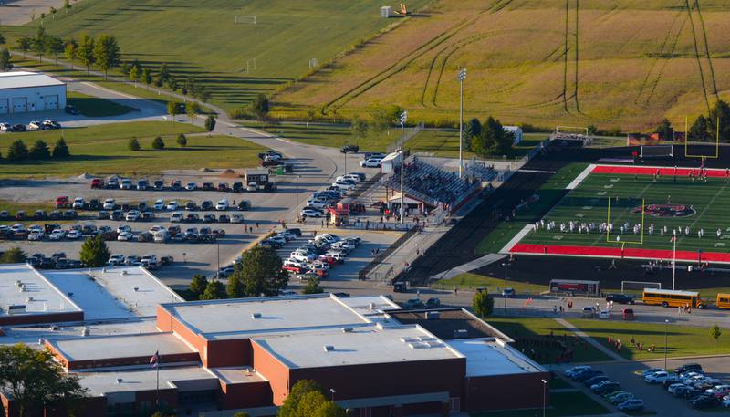 The district is looking to turn the gravel parking lot west of the football field into new tennis courts for the high school.