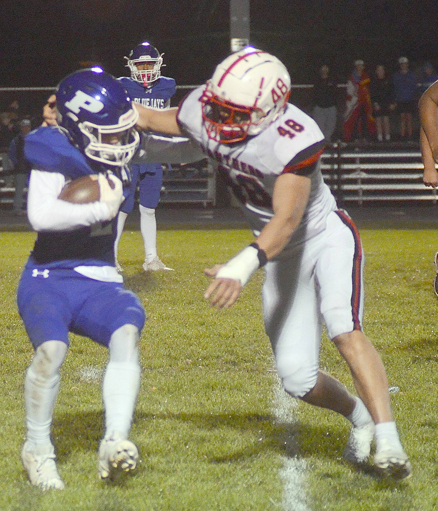 Creston defensive end Ethan Holliday (48) tackles Perry's Rylan Modlin for a loss in Friday's game. Holliday had two tackles for loss among his five tackles.