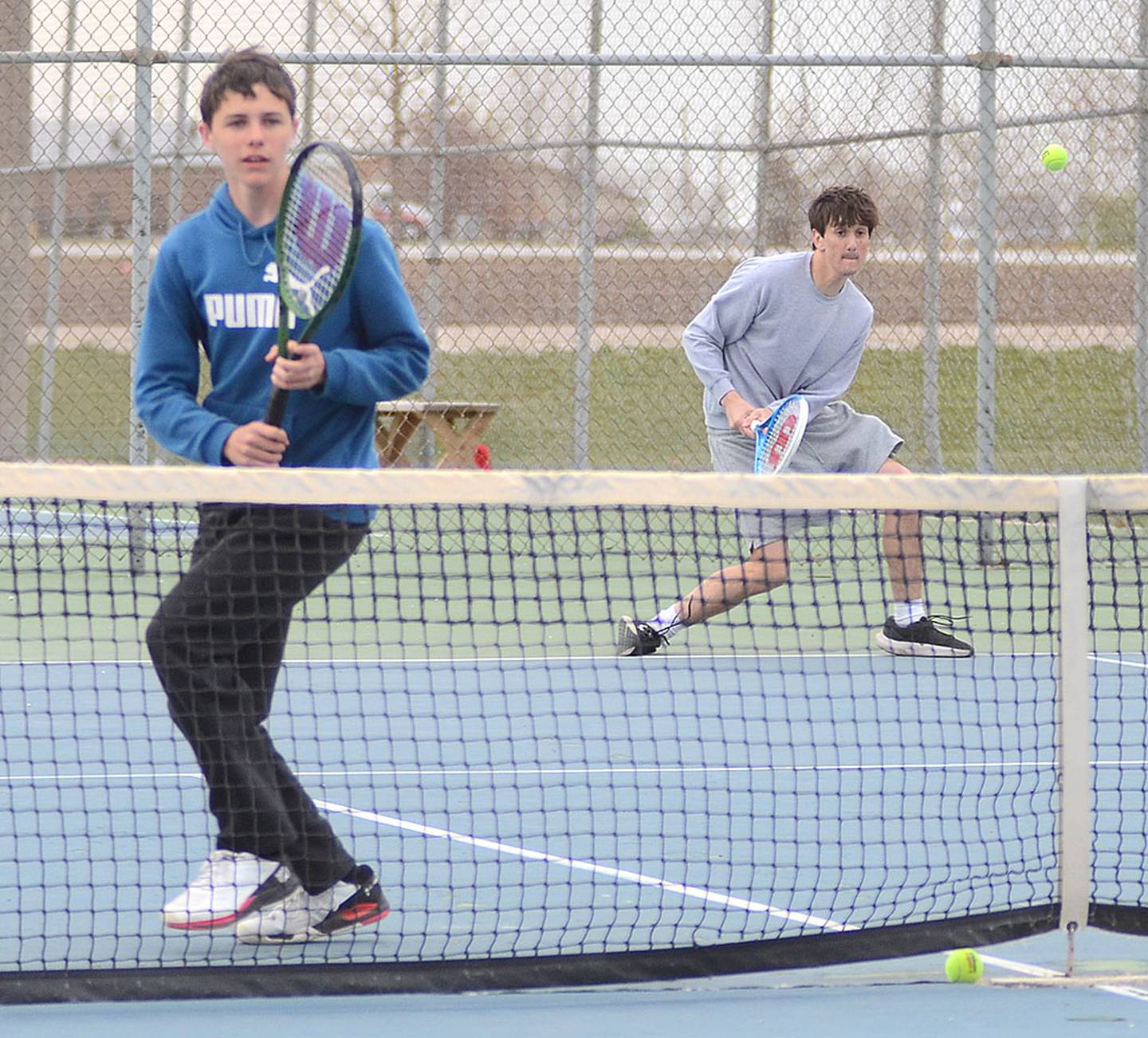 Brody Spark of Southwest Valley returns a shot as teammate Jordan Bruce (left) stands ready at the net during their 8-2 victory at No. 2 doubles Monday.