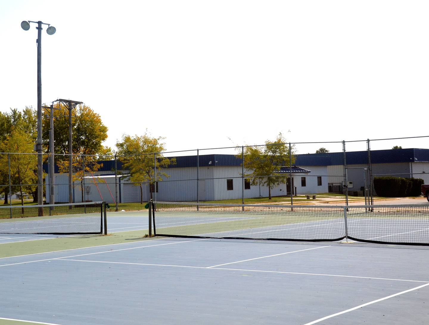 The new indoor practice athletic facility would be placed where the tennis courts currently reside.