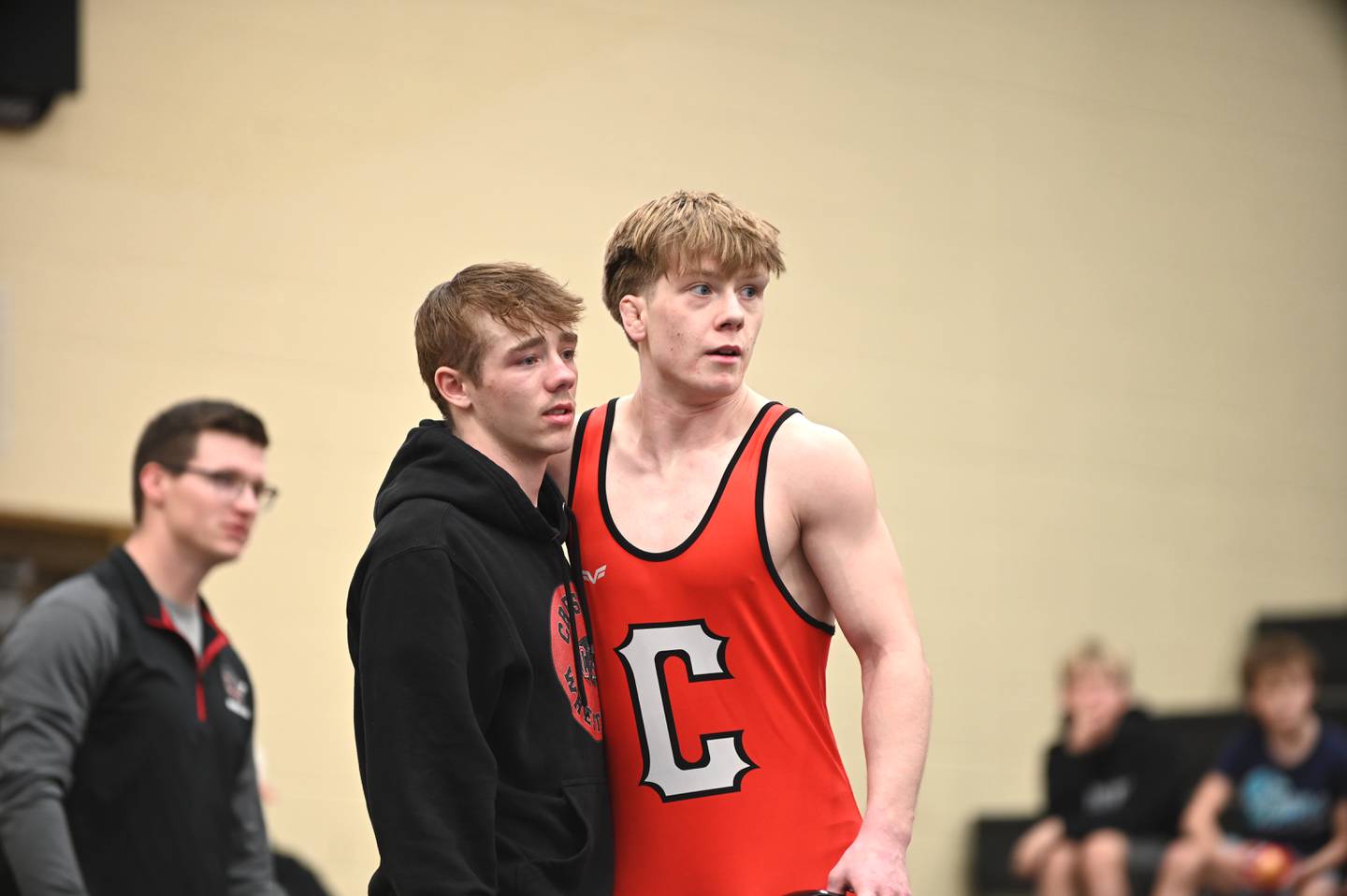 Kylen Parsons, left, and Brodrick Phelps, right, watch as the finals match at 144 concludes with Phelps not qualifying for a wrestleback.