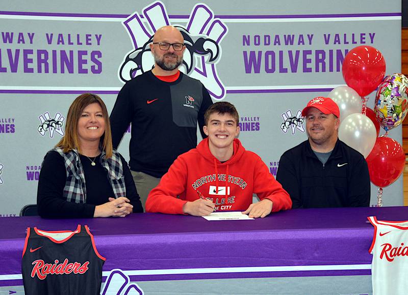With his parents Kerri and Joe and Northwestern College wrestling coach Rik Dahl,  Nodaway Valley senior Ty Strode signs Nov. 14 to wrestle for the Raiders next season.