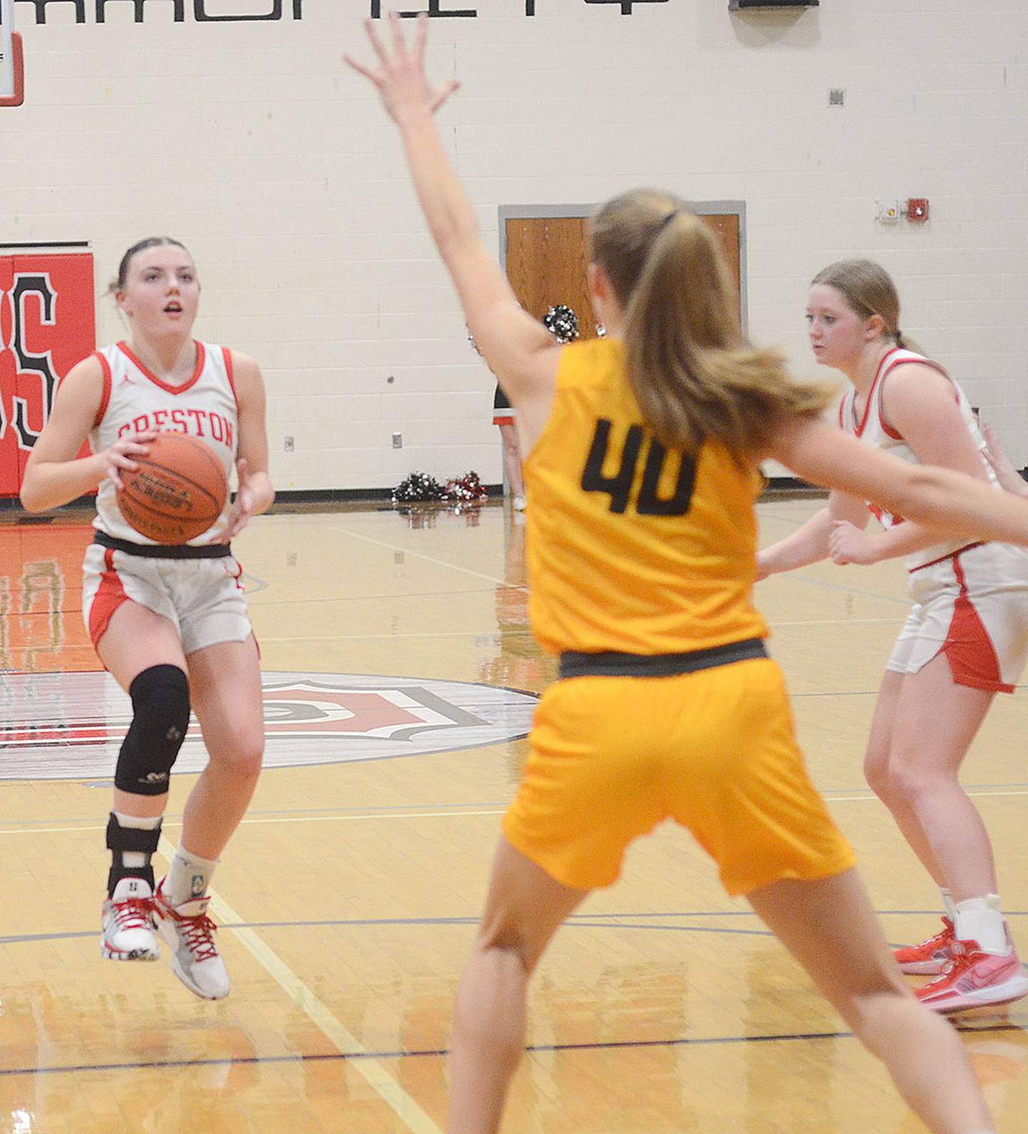 Creston point guard Hollynn Rieck stops in the lane as Atlantic center Katrina Williams (40) defends the play. Rieck became the second Panther to surpass 200 career assists in handing out four assists in the 47-28 loss. Rieck is second behind all-time assist leader Lindsay Cornick.