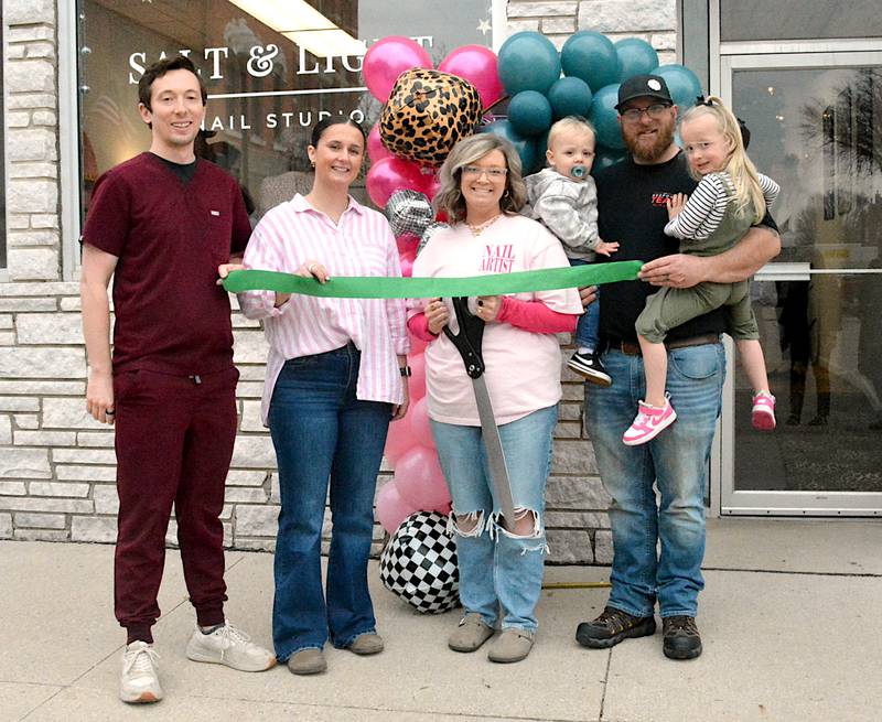 Maggie and Jared Masker (right), with children Jay and Maddax, as well as Greenfield Chamber Main Street President Dr. Ryan Frost and Vice President Bailey Grantham, last Wednesday morning at a ribbon cutting for Salt and Light Nail Studio at 178 Public Square.