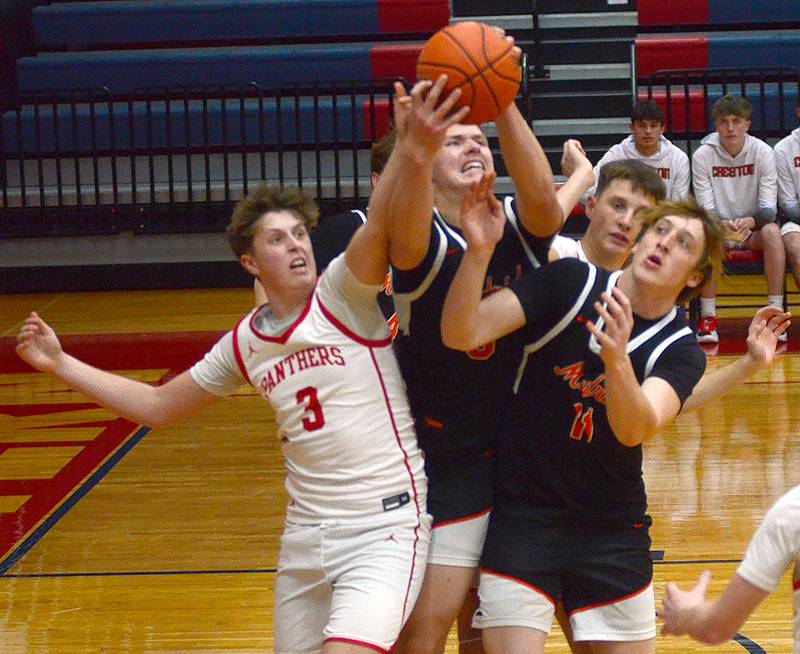 Creston's Rhett Driskell (3) battles Jevyn Severson (middle) and Emerson Bridgwater (right) of Madrid for a rebound during Thursday's game at Southwestern Community College. Driskell had a team-high 10 rebounds and 10 points in the 64-58 loss in double overtime.