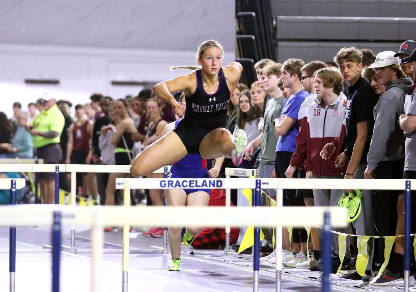 Annika Nelson of Nodaway Valley clears a hurdle in a first-place time of :09.06.