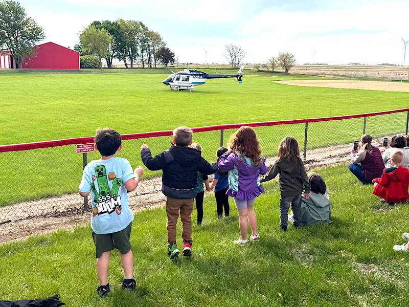 Orient-Macksburg preschool students get excited as their classmates arrive on a helicopter, flown by Kris Petter.