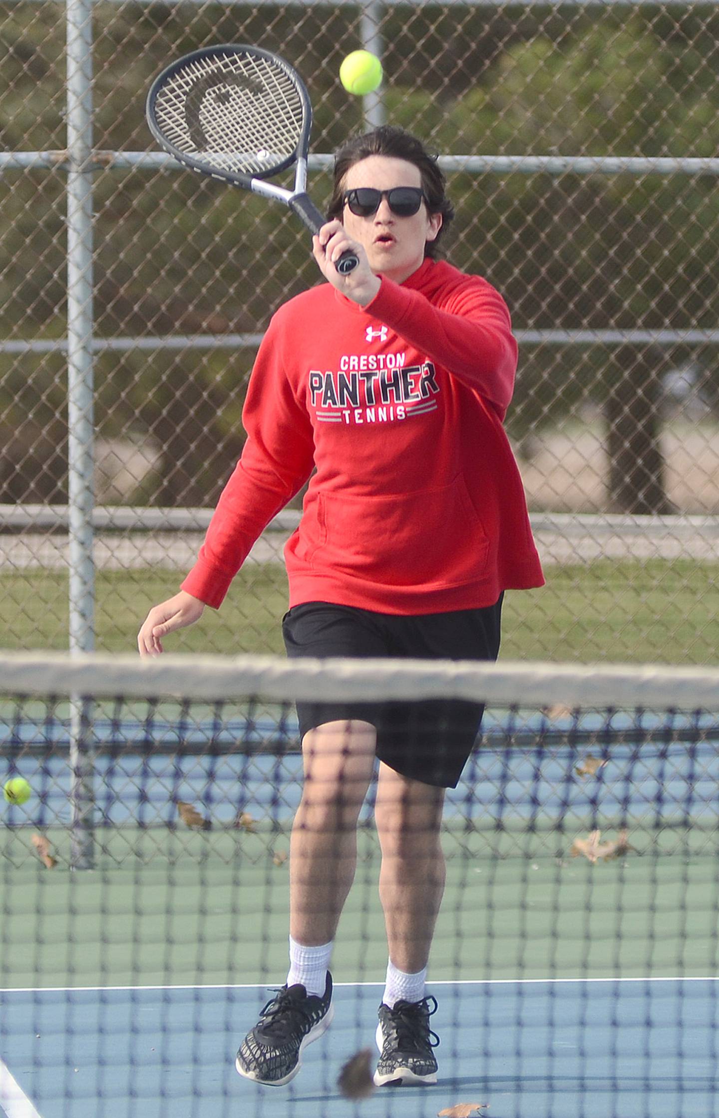 Spencer Brown of Creston punches a volley shot at the net in his match against Clarinda Monday. Brown and Carson Cooper won at 8-2 at No. 3 doubles to help the Panthers secure a 6-3 team victory.