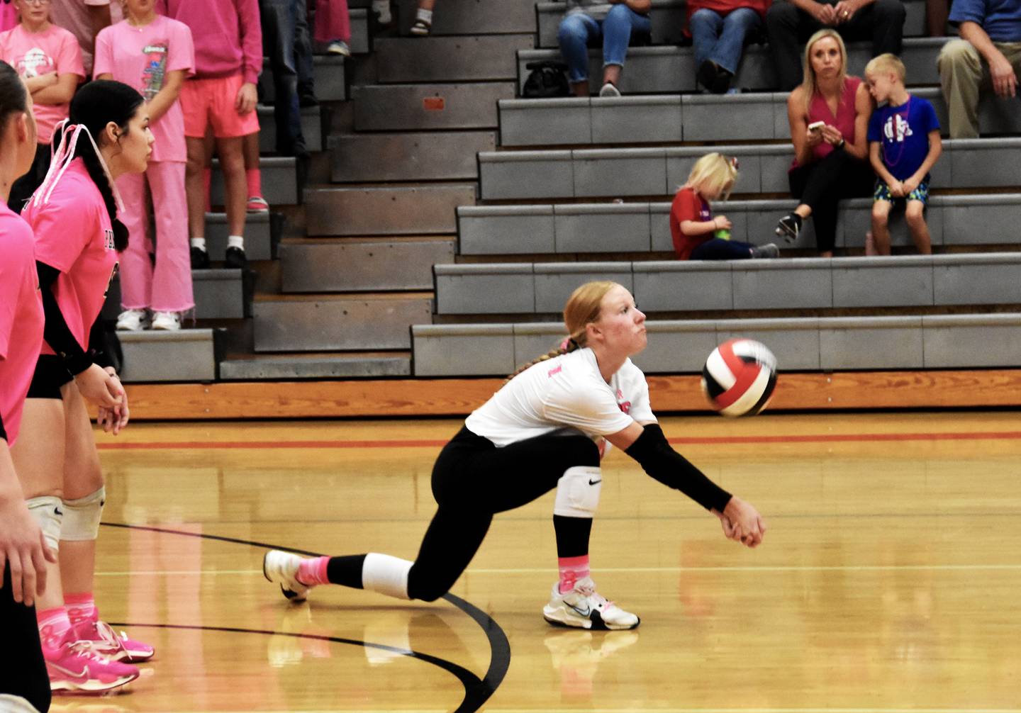 Libero Avery Staver goes on a knee to meet the ball. She had 20 digs on the night.