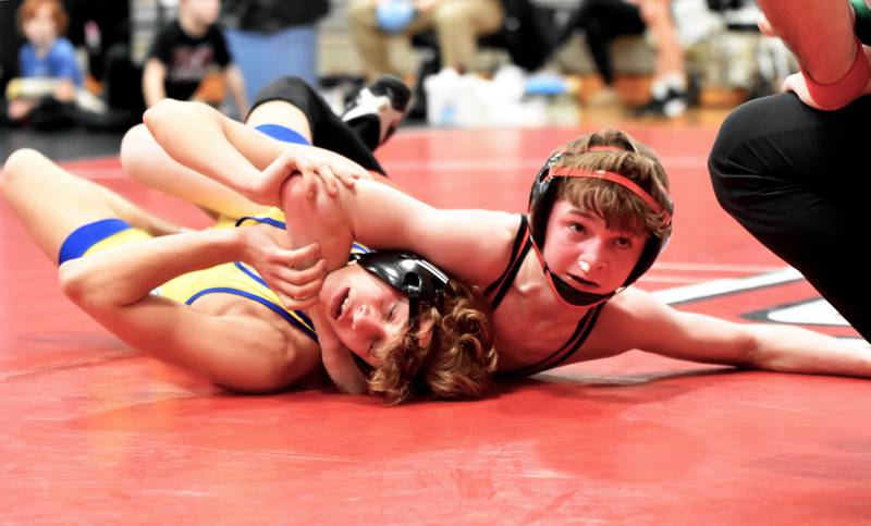 Creston freshman Colt Key holds Devin Webb of Martensdale St. Marys to the mat. Key won the 106-pound bout 12-9.