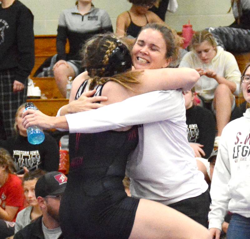 SWAT senior Grace Britten and head coach Tiffany South embrace after Britten won her division at the Valkyries' scramble held at Nodaway Valley Monday, Nov. 13.