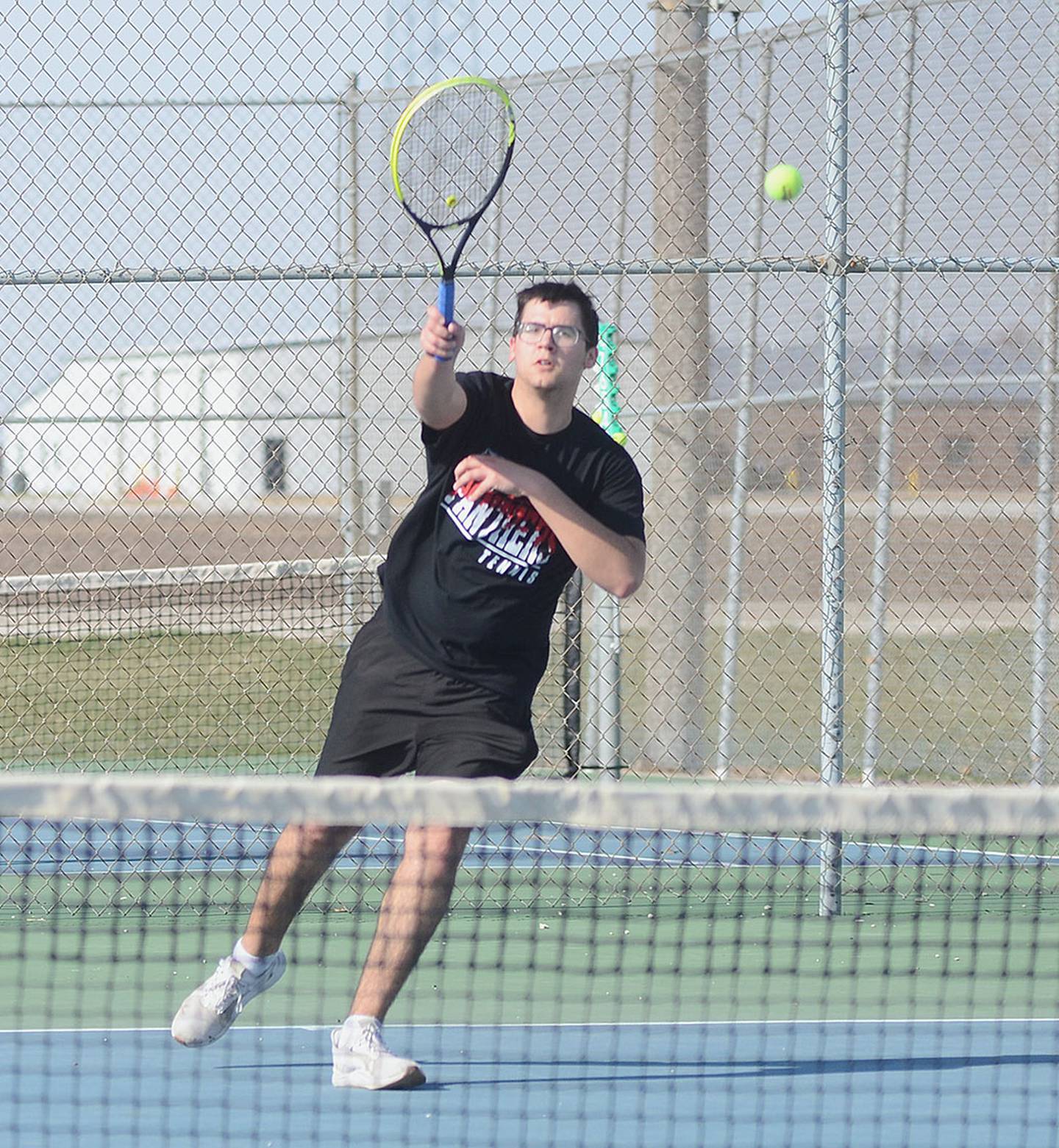 Wesley Wires of Creston hits an overhand volley during his match against Red Oak Tuesday.