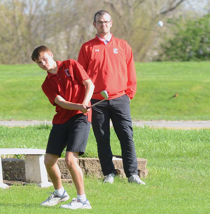 Creston assistant coach Bryce Schafer watches as Branden Spencer chips onto the No. 9 green at Crestmoor Golf Club. Spencer shot 45 as the Panthers placed second in Monday's triangular.