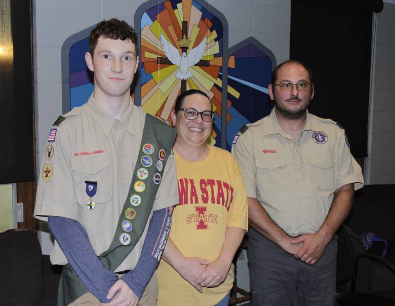 Tyler Cooper with his mother, Cori, and Scoutmaster Jeremy Rohner last summer after he completed the requirements of his Eagle Scout rank. He was recognized for it last weekend at a district dinner in Manning.