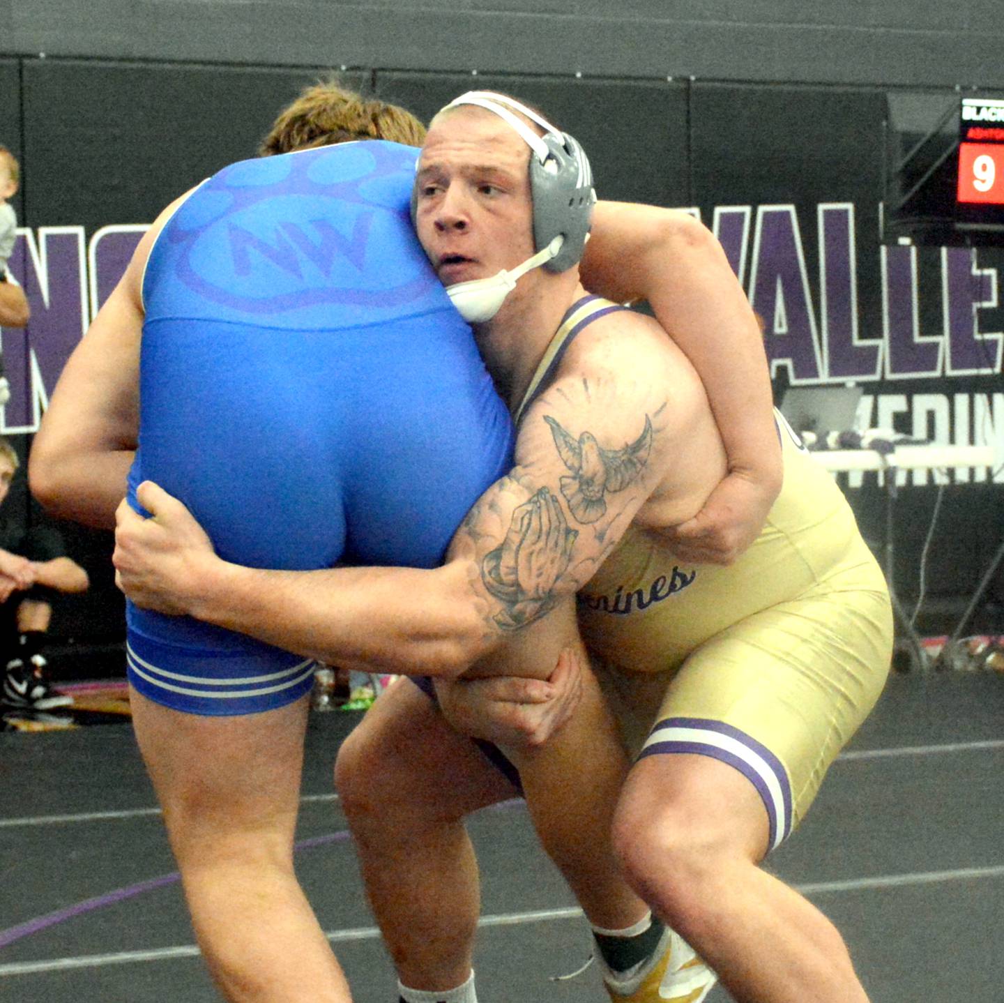 NV senior Ashton Honnold takes down Waukee Northwest JV's Gabe Winter in the 285-pound championship of the Coach Riley Invitational.