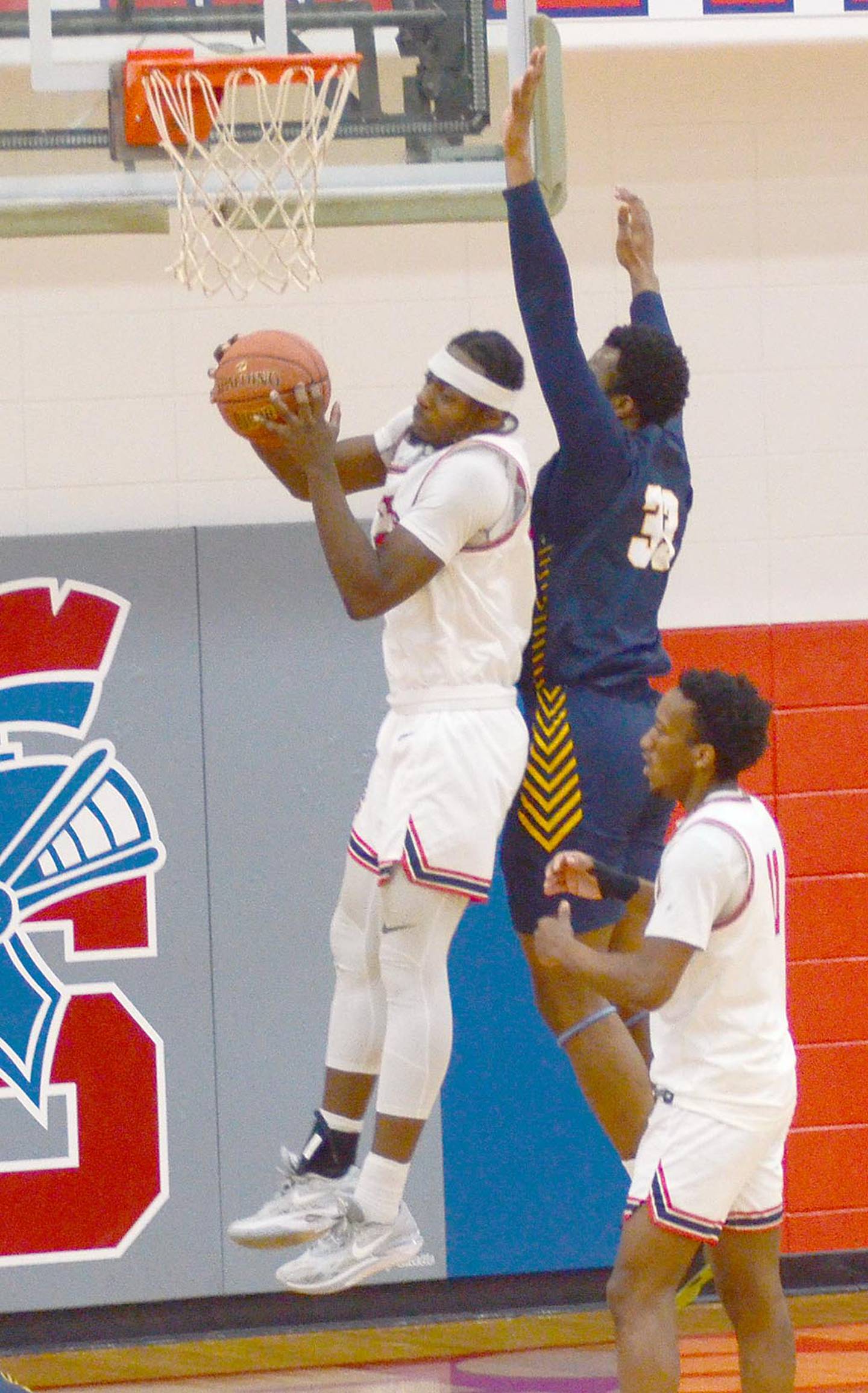 Gerlouis Tokody of Southwestern grabs a rebound against Iowa Lakes Saturday.