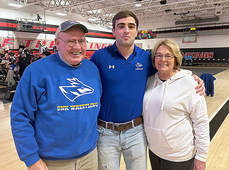 Nebraska-Kearney wrestler Jackson Kinsella of Creston is shown with grandparents Dennis and Kay Kinsella of Creston prior to last week's dual meet at Grand View. Kinsella was held out of competition that night with an ankle injury, but is slated to return to action this weekend.