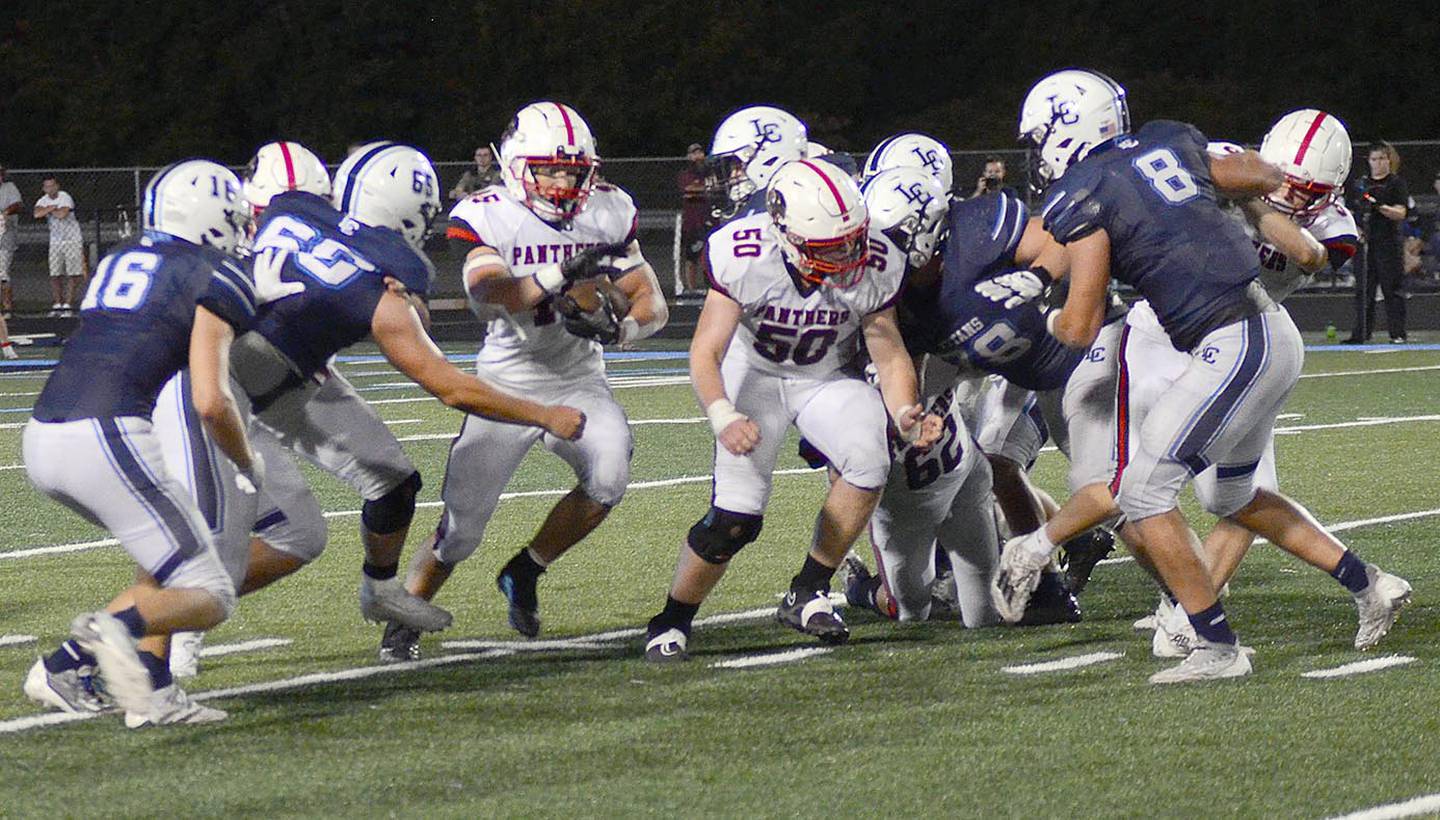 Creston running back Brennan Hayes runs behind the blocking of Tucker Rohrig (50) on his way to 190 yards rushing in Friday;s 22-20 victory. Hayes scored on a 73-yard touchdown.