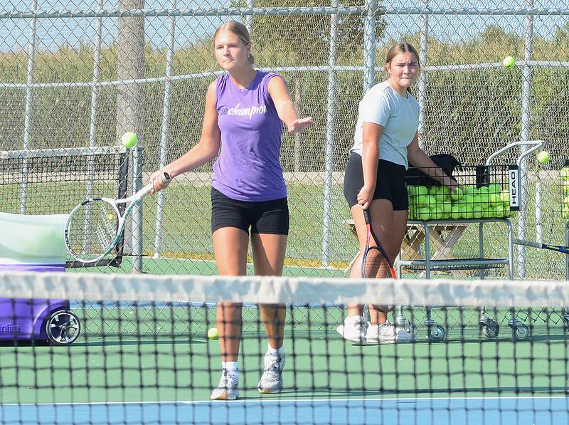 Creston sophomore Marlee Stalker returns a shot during a practice this week as teammate Shaylee Coen looks on. Stalker and Coen were regulars in the varsity lineup last spring for Creston.