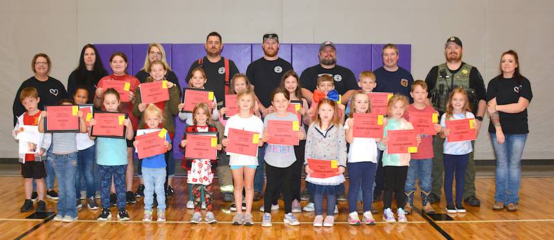 Winners of the coloring page contest with Greenfield firefighters and Firemates at a recent assembly at Nodaway Valley Elementary School.