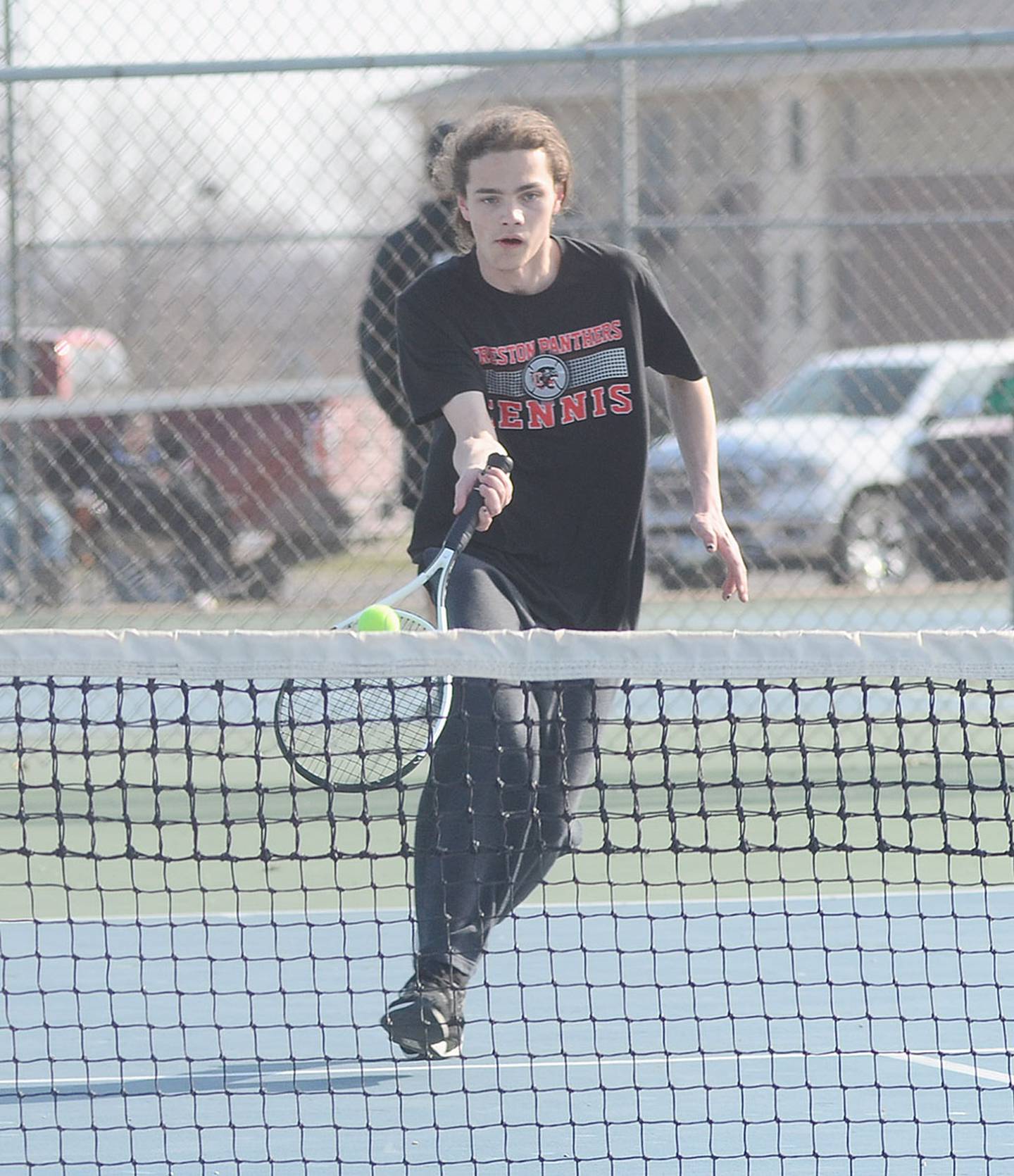 Creston junior Carson Beer approaches the net to return a shot against Red Oak Tuesday.