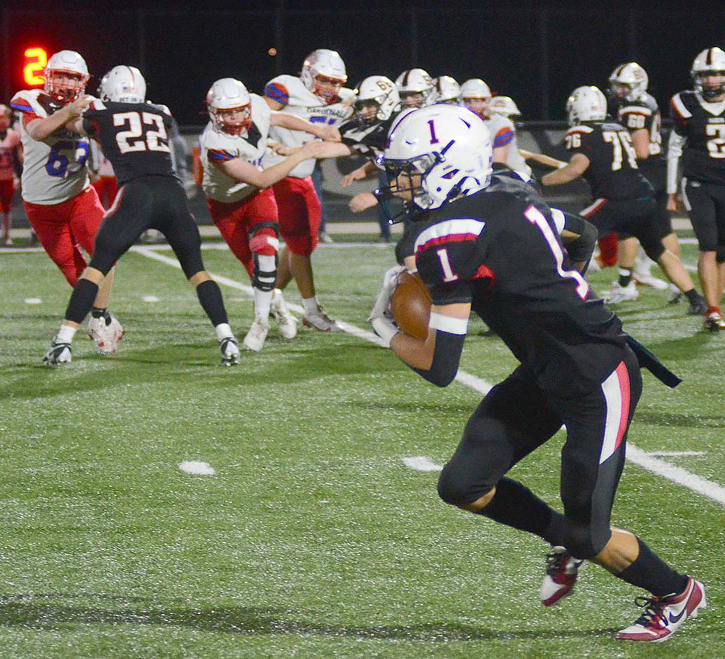 Trevin Victor of Mount Ayr (1) heads up field after receiving a pass from Jackson Ruggles during Friday's playoff game. Victor returned a punt 80 yards for a touchdown in the first quarter.