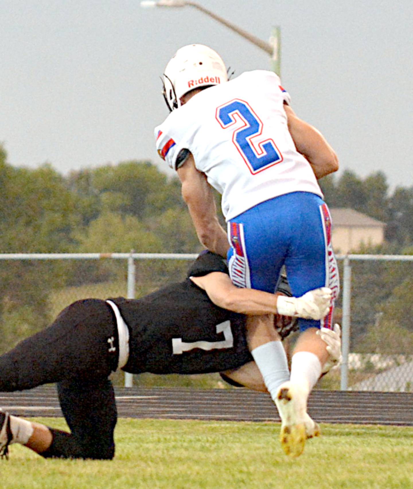 NV/OM junior Bram Dahl (7) goes for a double-leg takedown of AHSTW's Gavin Gettler during last Friday's homecoming game.