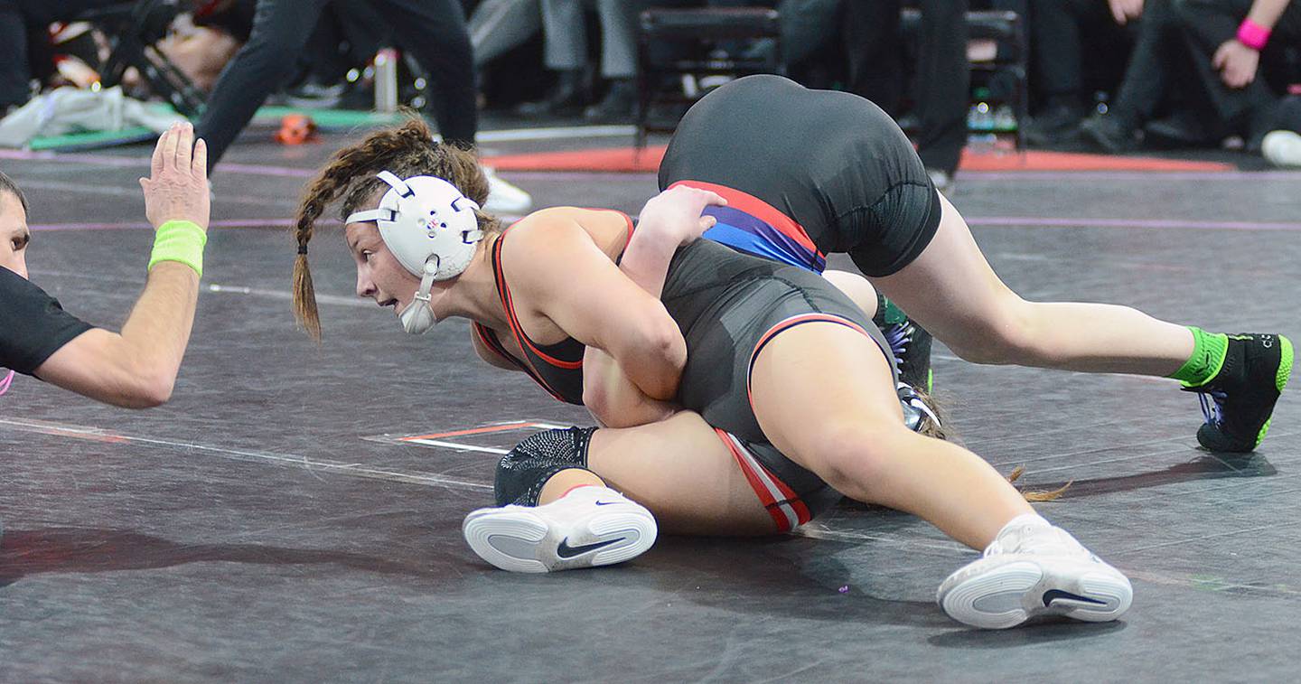 Grace Keeler of Creston looks to the official to signal a pin moments before ending her consolation match against Raccoon River-Northwest's Bethann Templeman. The win assured Keeler of medaling at 135 pounds.
