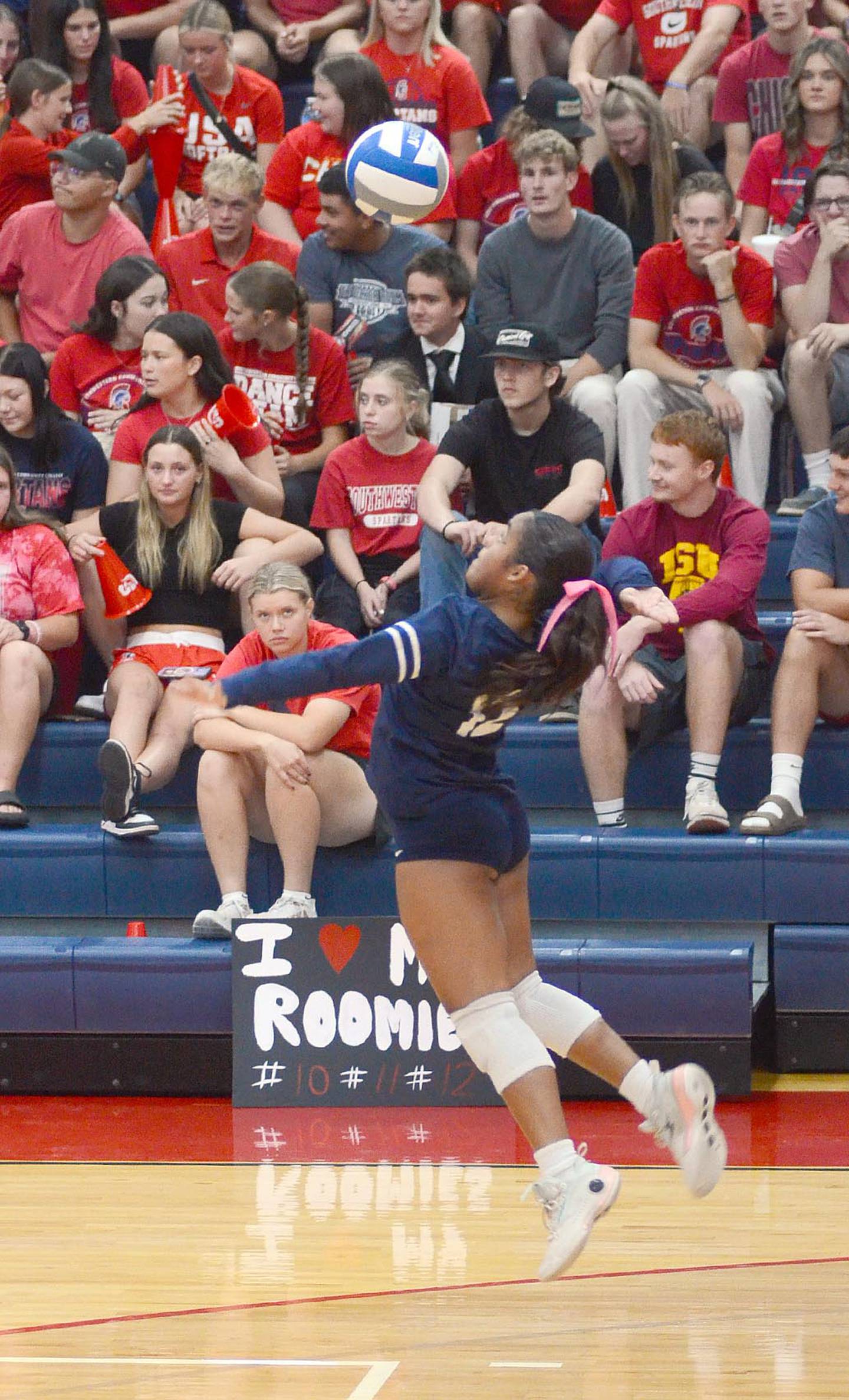 Whitney Hollins (22) and Cadence Perkins (13) of Southwestern reach for a block against Southeastern middle hitter Taryn Havener. Hollins had a team-high four solo blocks and two assisted blocks and added five kills in the loss.