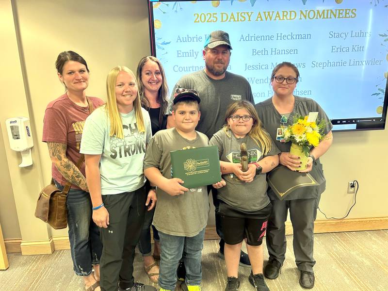 Stacy Luhrs (right) receives the DAISY Award at Adair County Health System, joined by her family.