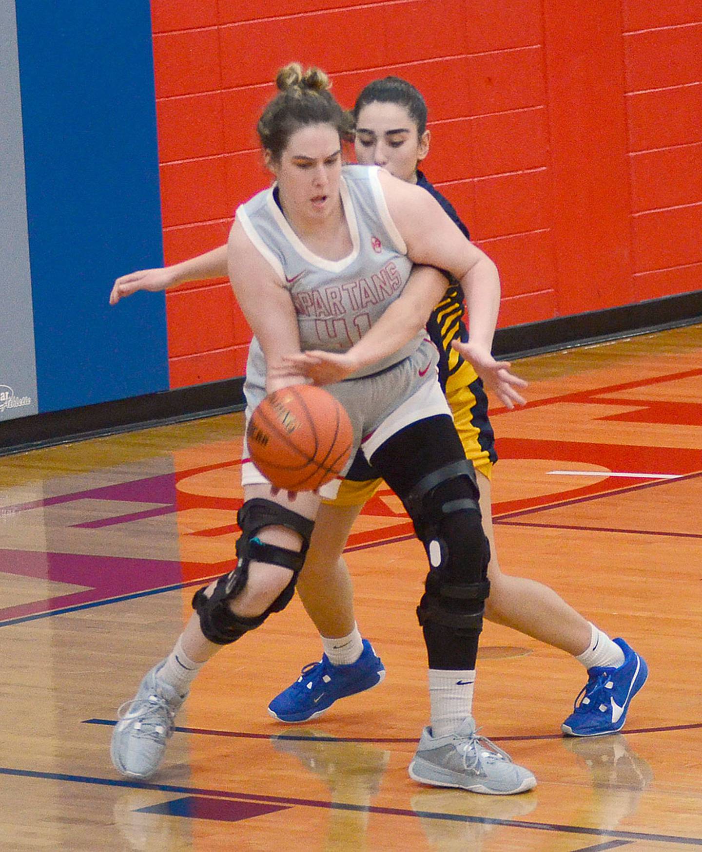 Southwestern center Mikayla Hearon receives a pass against a Marshalltown defender. Hearon scored 12 points in the 64-46 victory.