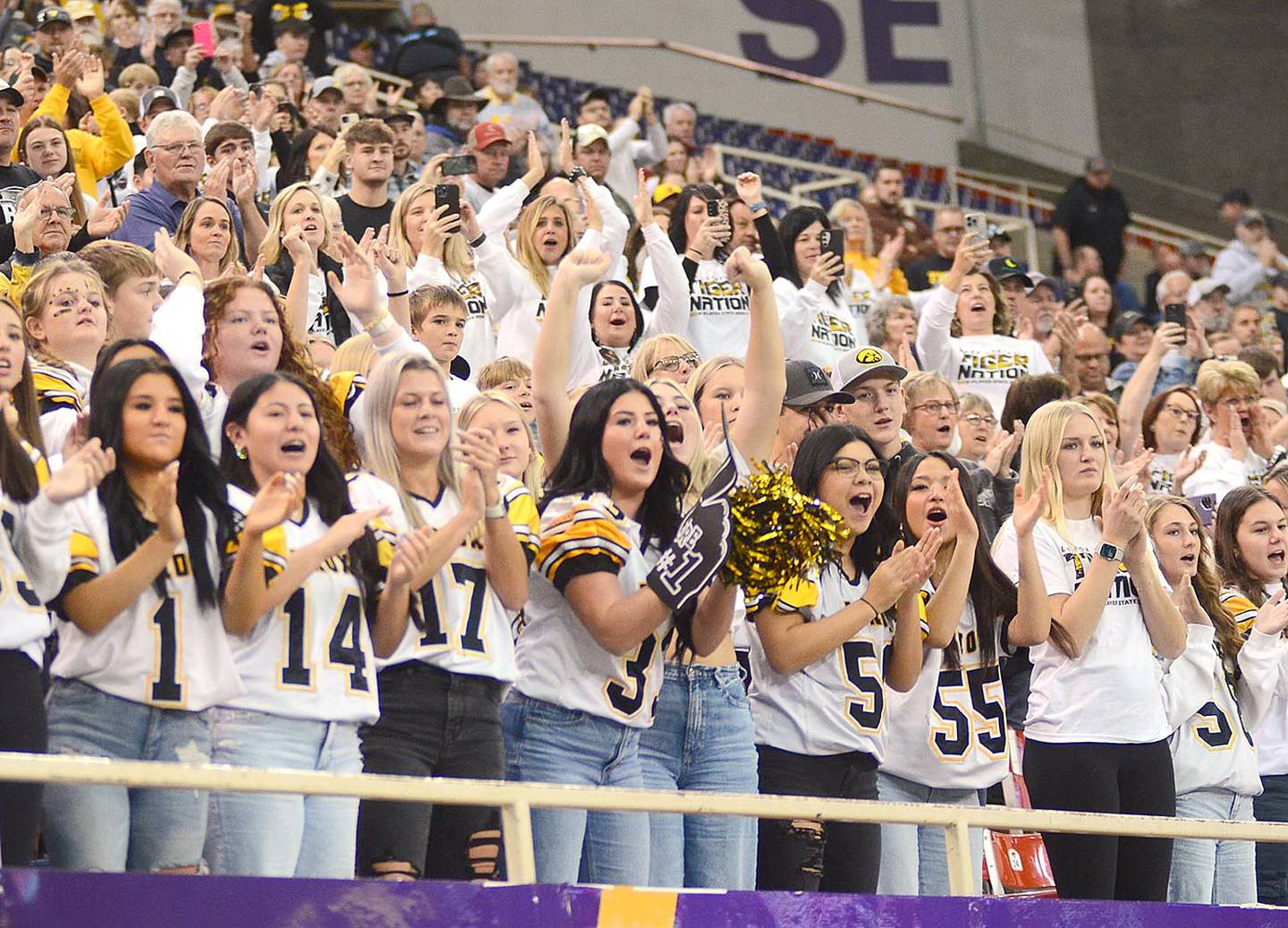 The Lenox student section cheers the football team as it takes the field for Wednesday's playoff semifinal game against Gladbrook-Reinbeck in the UNI-Dome.