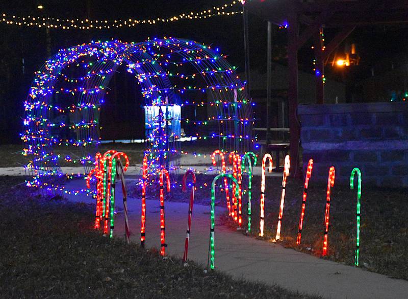 Christmas lights give a colorful invitation in the Afton park square. Candy canes and reindeer light up the night with cheer.