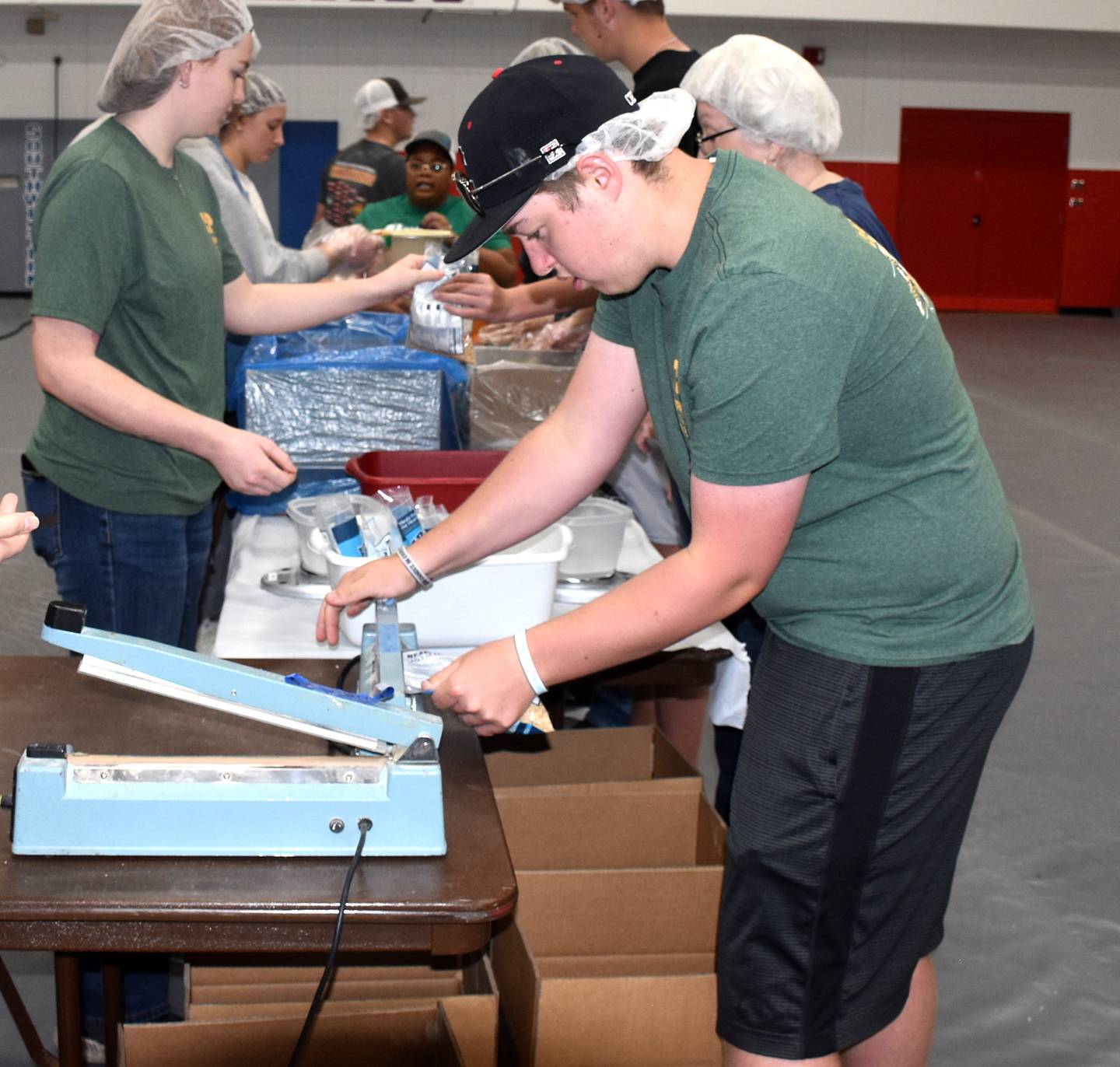 Dornack helps to package meals in April during Meals of the Heartland.
