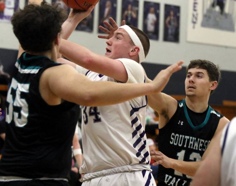 Wolverine senior Jacob Fry battles through traffic for a contested jump shot last Tuesday night against Earlham.