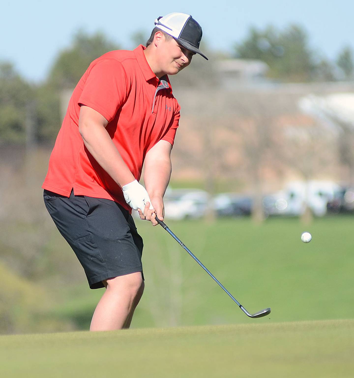 Chasse Downing of Creston chips onto the No. 3 green during Monday's home meet. Downing shot 45 as the Panthers placed second.