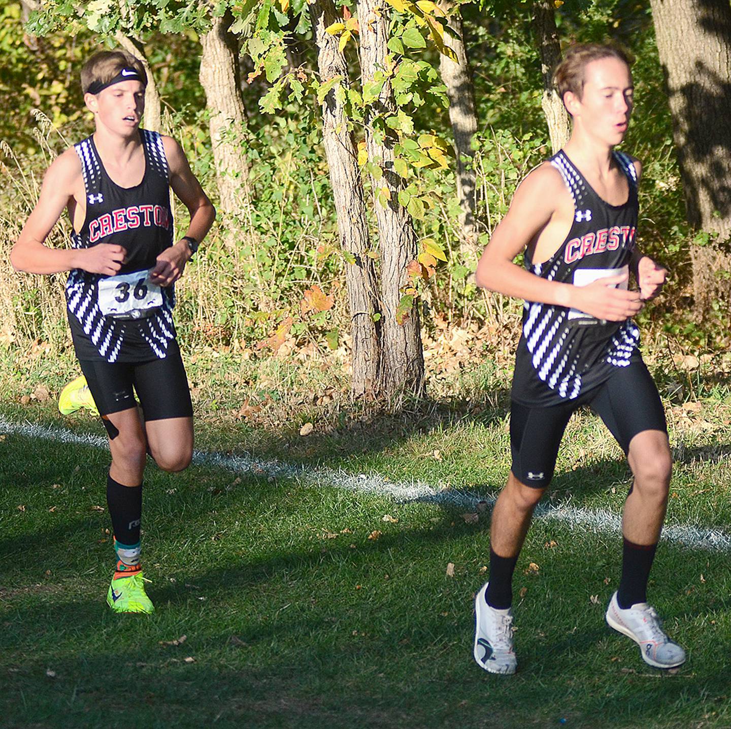 Creston's Ryder Baird (left) and Wyatt Goodenberger run near the 3K marker in Wednesday's state qualifying race. Baird was the leading Panther runner in 22nd in 17:31.11. Goodenberger finished 64th in 19:44.55.