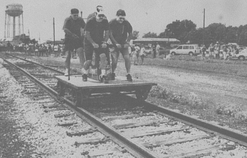 Members of the Creston Volunteer Fire Department team #2 pump during the handcar race held Saturday on the railroad tracks south of the sale barn.