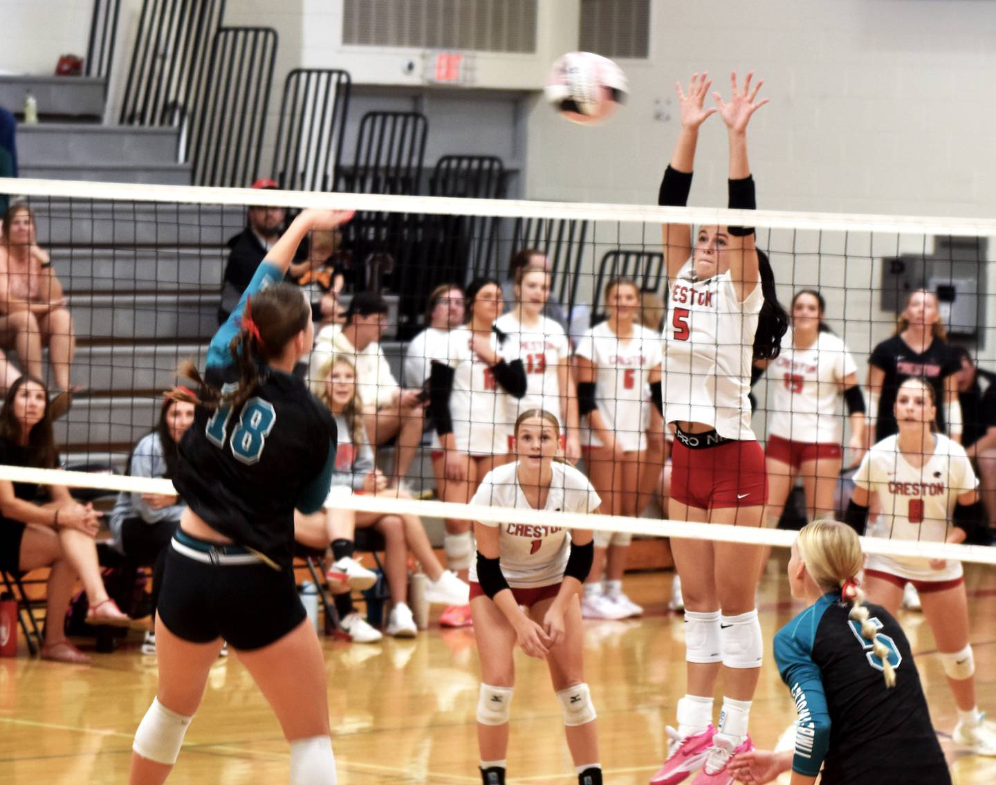 Braylee Pokorny jumps to block a shot by Mackenzie Fast. Pokorny logged three solo blocks and an assist.