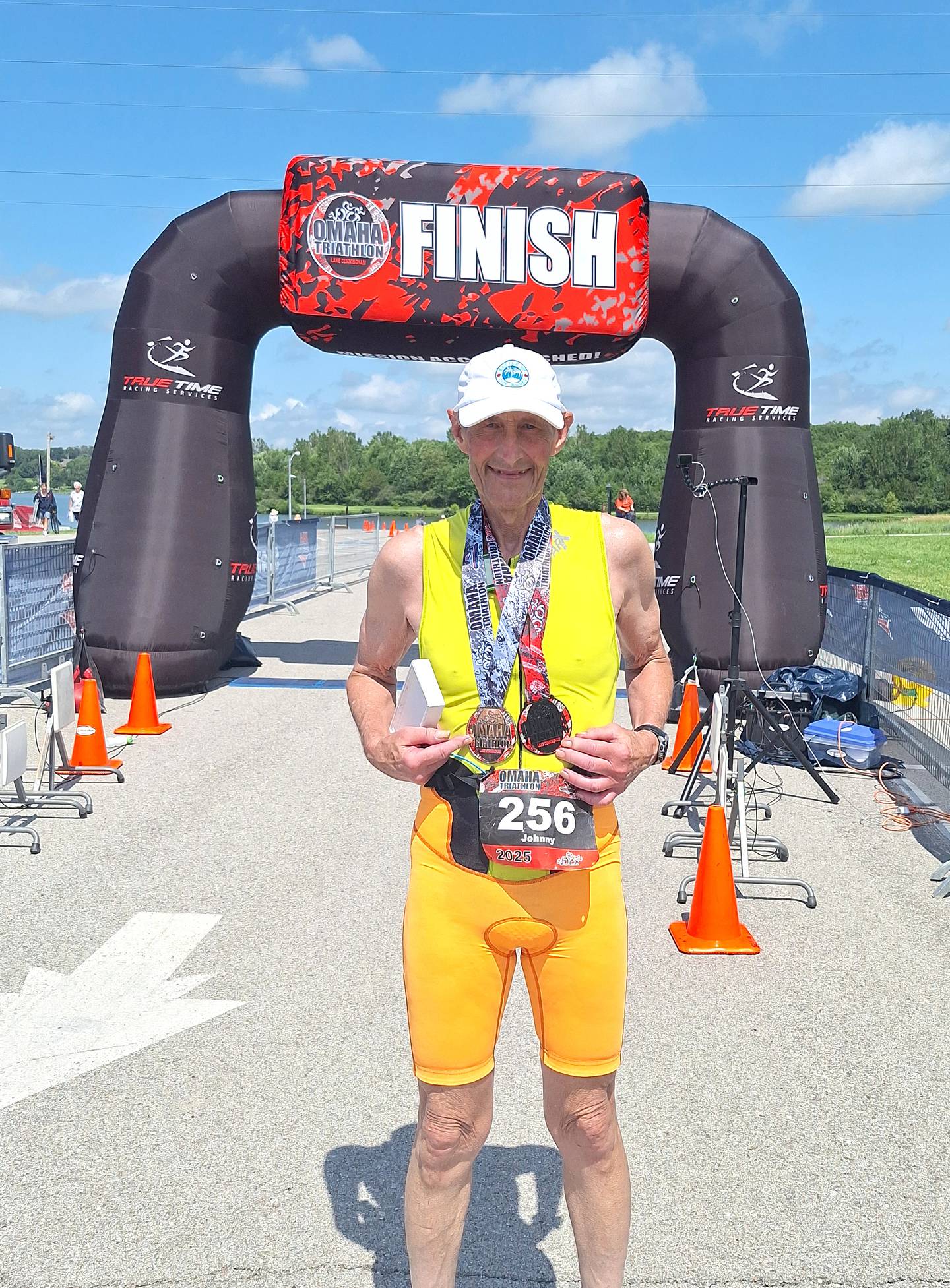 Ytzen poses with his medals for finishing and placing in his age group at the Omaha Triathlon.