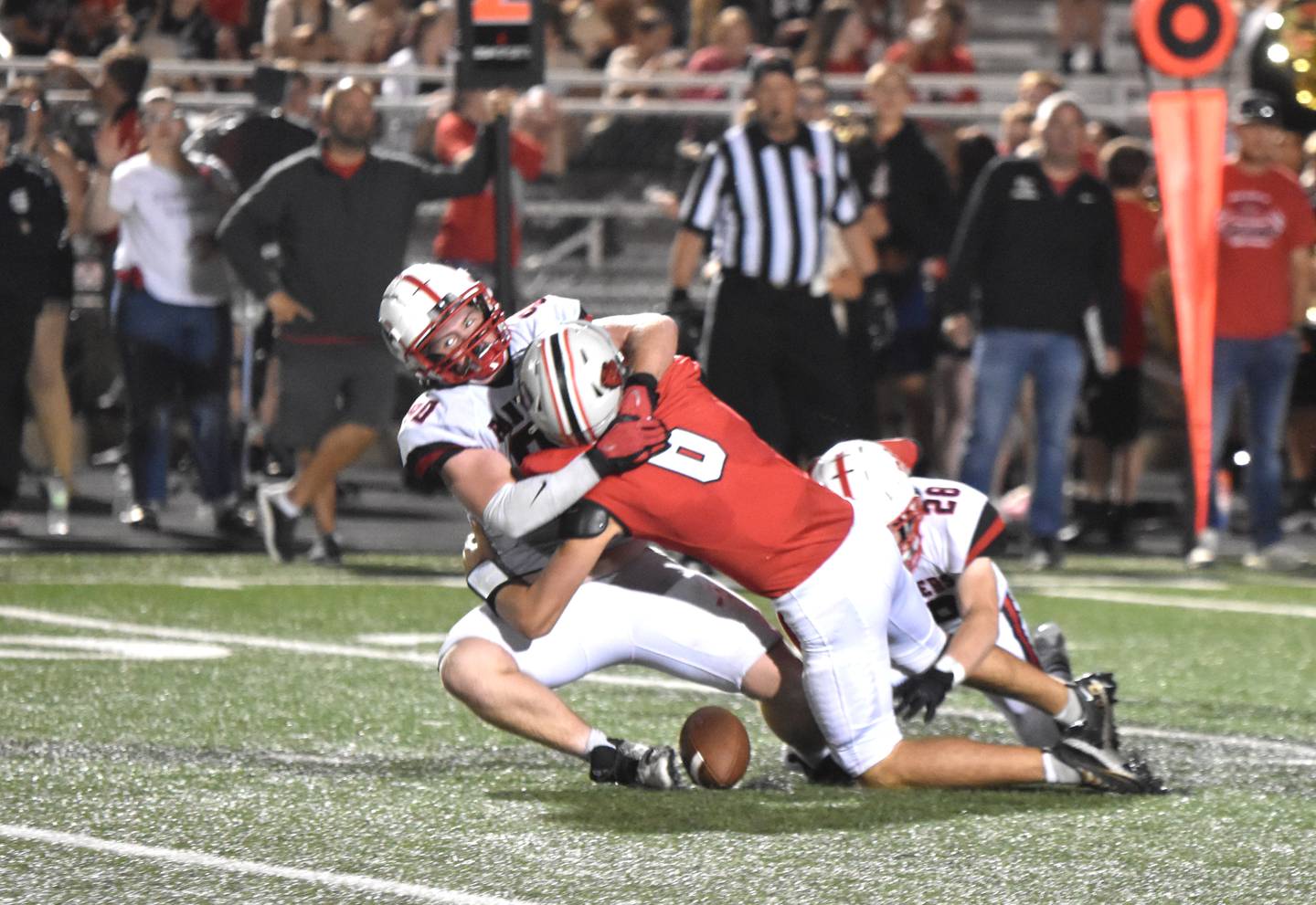 Sophomore Tom Mikkelsen (No. 90) gets a sack on Harlan quarterback Gabe Arkfeld. The ball came loose on the play, but refs ruled forward progress had been stopped prior to the fumble. Mikkelsen had 2.5 tackles for loss.