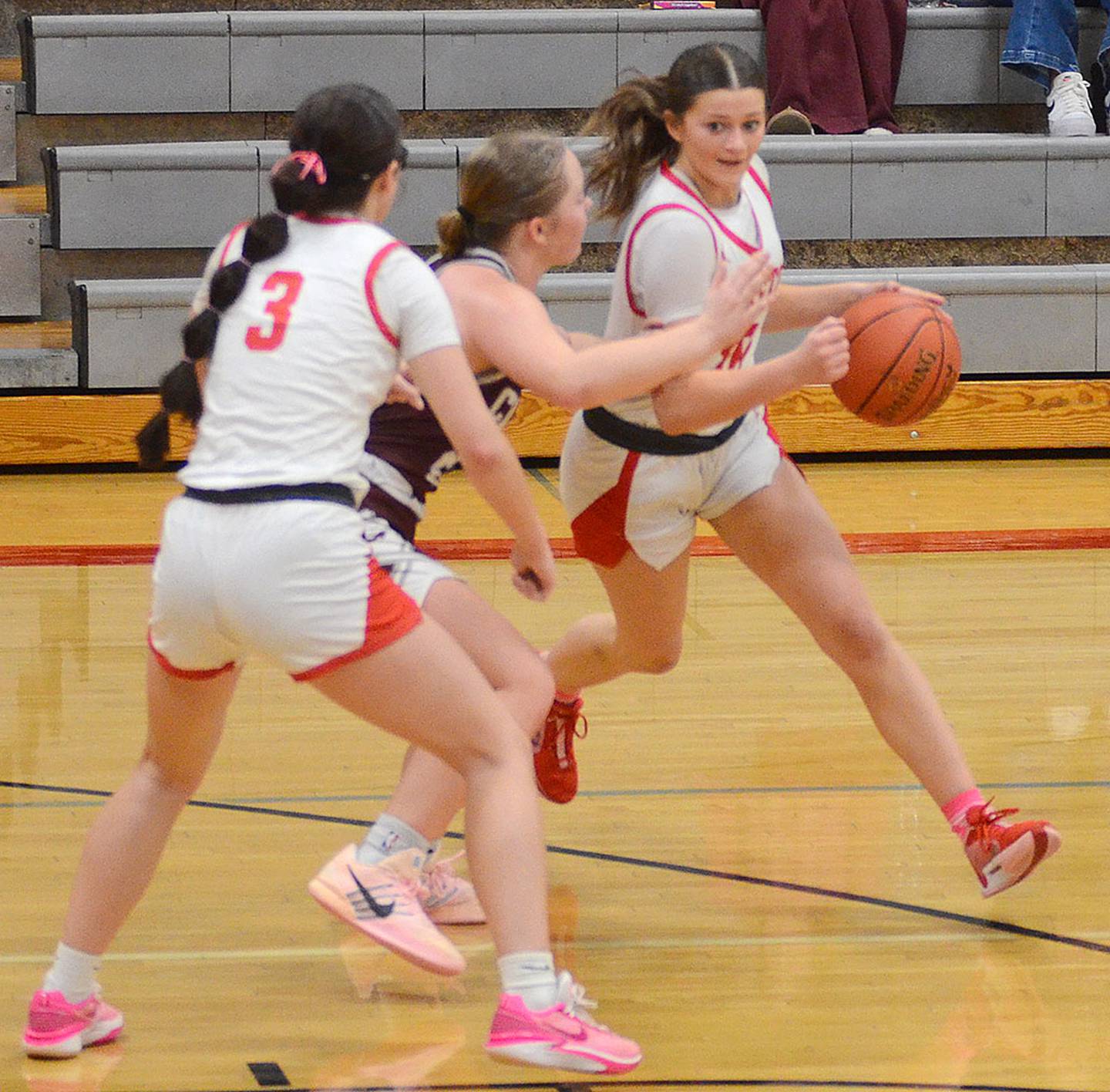 Jensan Tussey of Creston dribbles around a screen set by Braylee Pokorny (3). Tussey scored seven points in the victory. Pokorny grabbed 13 rebounds and scored five points.